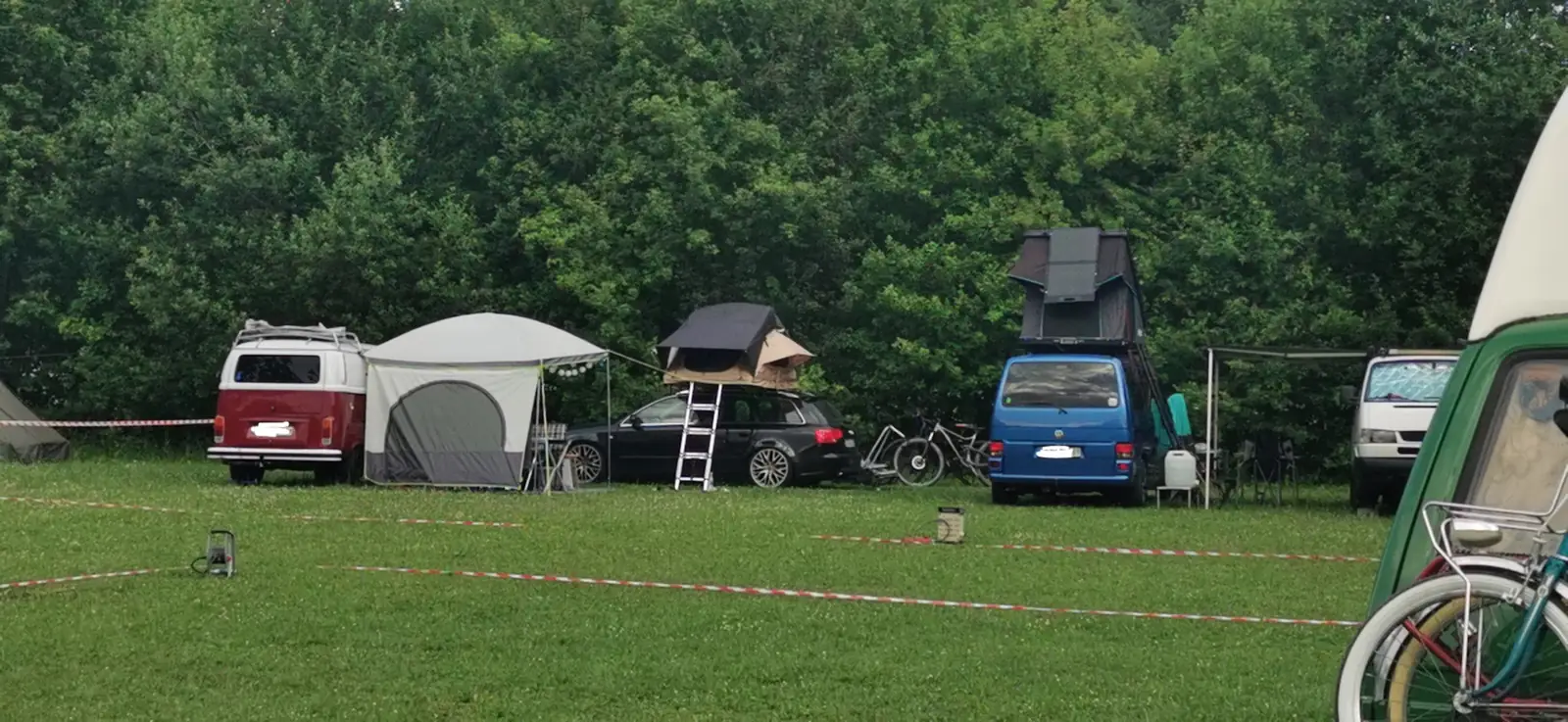 Bullis, Dachzelte und Campingausrüstung am Waldrand